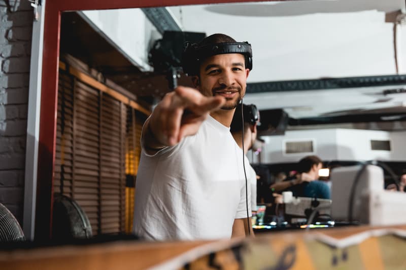 Austin Ventour smiling and pointing at the camera from the DJ booth
